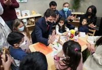 Canadian Prime Minister Justin Trudeau high-fives a child as he plays with children after reaching and agreement in $10-a-day child-care program deal in Brampton, Ont., on Monday, March 28, 2022.THE CANADIAN PRESS/Nathan Denette
