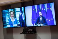 European Council President Charles Michel, right, and European Commission President Ursula von der Leyen are seen on screen as they hold a videoconference at the European Council building, in Brussels, on June 15, 2020.