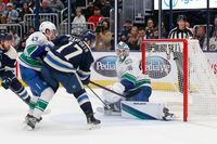 Oct 18, 2022; Columbus, Ohio, USA; Columbus Blue Jackets right wing Justin Danforth (17) tips the puck past Vancouver Canucks goalie Spencer Martin (30) for a goal during the second period at Nationwide Arena. Mandatory Credit: Russell LaBounty-USA TODAY Sports