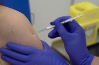 A screen grab taken from a video issued by Britain's Oxford University shows a person being injected as part of the first human trials in the United Kingdom to test a potential COVID-19 vaccine.