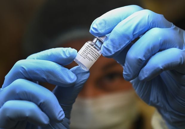 Health-care worker prepares dose of COVID-19 vaccine
