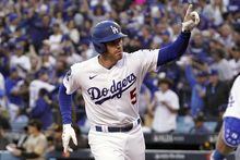 Los Angeles Dodgers' Freddie Freeman celebrates his solo home run against the San Diego Padres at home plate during the first inning in Game 2 of a baseball NL Division Series, Wednesday, Oct. 12, 2022, in Los Angeles. (AP Photo/Mark J. Terrill)