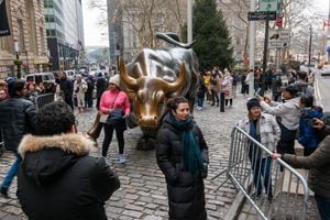 NEW YORK, NEW YORK - DECEMBER 26: People visit the Wall Street Bull on the first day back for the Stock Exchange since the Christmas holiday on December 26, 2023 in New York City. Markets were up slightly in morning trading during what is expected to be a light week for traders as many in the finance community are away for the Christmas week holiday. (Photo by Spencer Platt/Getty Images)