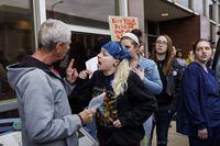 Barney Blacketer, 74, left, argues with Madison Thompson, 23, center, and Ariel Cravens, 23, outside the Robert E. Jones Municipal Building before members of the city council voted to approve an ordinance that would ban the mailing or shipping of abortion pills, Tuesday, May 2, 2023 in Danville, Ill. The Illinois city near its eastern border with Indiana on Tuesday banned the mailing or shipping of abortion pills, defying the state's Democratic attorney general and the American Civil Liberties Union who have repeatedly warned that the move violates Illinois law's protection of abortion as a fundamental right. (Armando L. Sanchez/Chicago Tribune via AP)