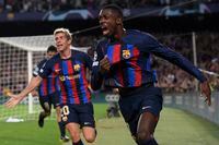 Barcelona's French forward Ousmane Dembele (R) celebrates scoring the opening goal during the UEFA Champions League 1st round, group C, football match between FC Barcelona and Inter Milan at the Camp Nou stadium in Barcelona on October 12, 2022. (Photo by Josep LAGO / AFP) (Photo by JOSEP LAGO/AFP via Getty Images)