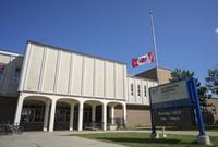 The flag flies at half mast at Sir Winston Churchill Secondary School, near where a 14-year old student was stabbed to death, in Hamilton, Ont., on Oct. 6, 2019.