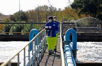 A worker collects a sample of waste water to be sent to a laboratory for close examination to monitor the coronavirus in the water at a sewage works in Anzio, near Rome, Italy, November 3, 2020. Picture taken November 3, 2020. REUTERS/Yara Nardi