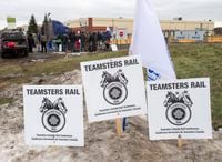 Striking Canadian National Railway workers picket in front of the company's Taschereau railyard on Nov. 25, 2019 in Montreal.