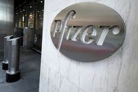 FILE PHOTO: The Pfizer logo is pictured on their headquarters building in the Manhattan borough of New York City, New York, U.S., November 9, 2020. REUTERS/Carlo Allegri