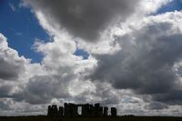 FILE PHOTO: A view of the silhouetted Stonehenge stone circle, where official Summer Solstice celebrations were cancelled due to the spread of the coronavirus disease (COVID-19), near Amesbury, Britain June 20, 2020. REUTERS/Toby Melville/File Photo