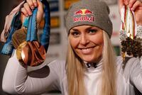 FILE - Lindsey Vonn shows medals from her career as she holds a press conference after taking the bronze medal in the women's downhill race, at the alpine ski World Championships in Are, Sweden, Sunday, Feb. 10, 2019. Lindsey Vonn, Michelle Kwan, Mia Hamm, Billie Jean King and the late Pat Summitt are among the nine individual women who will be inducted into the U.S. Olympic and Paralympic Hall of Fame this summer. (AP Photo/Gabriele Facciotti, File)