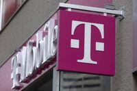 FILE - The T-Mobile logo is seen on a storefront, Oct. 14, 2022, in Boston. U.S. wireless carrier T-Mobile announced Wednesday, March 15, 2023, that it is buying prepaid wireless brand Mint Mobile, in which actor Ryan Reynolds is a part owner, as part of a cash-and-stock deal worth up to $1.35 billion. (AP Photo/Michael Dwyer, File)