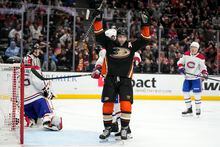 Anaheim Ducks right wing Troy Terry, center, celebrates a goal by center Mason McTavish as Montreal Canadiens goaltender Sam Montembeault, left, sits in goal during the third period of an NHL hockey game Friday, March 3, 2023, in Anaheim, Calif. (AP Photo/Mark J. Terrill)