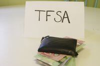 a sign that says TFSA next to a wallet that has money in it. Theme of Canadian savings. TFSA stands for tax free savings account.