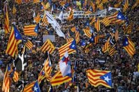 Demonstrators wave Catalan pro-independence "Estelada" flags during a protest marking the "Diada", the national day of Catalonia, in Barcelona on September 11, 2022. - The protest coincides with Catalonia's national day, or "Diada", which commemorates the 1714 fall of Barcelona in the War of the Spanish Succession and the region's subsequent loss of institutions. (Photo by Josep LAGO / AFP) (Photo by JOSEP LAGO/AFP via Getty Images)