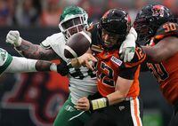 B.C. Lions quarterback Nathan Rourke is sacked by Saskatchewan Roughriders' Garrett Marino, back, and fumbles the ball during the first half of a pre-season CFL football game in Vancouver, B.C., Friday, June 3, 2022. THE CANADIAN PRESS/Darryl Dyck