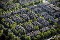 A neighbourhood of townhouses is seen in an aerial view in Richmond, B.C., on Wednesday May 16, 2018. Canada Mortgage and Housing Corp. says the jumping home prices seen in many cities this summer and fall was beyond what could be justified by Canadian income levels and population growth.THE CANADIAN PRESS/Darryl Dyck