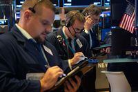 Traders work on the floor at the closing bell on the New York Stock Exchange.