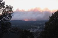 A wildfire burning on the outskirts of Flagstaff, Arizona, on Sunday, June 12, casts a glow above neighborhoods. Evacuations have been ordered for homes in the area. Authorities say firefighters are responding to the wildfire about six miles north of Flagstaff that has forced evacuations. (AP Photo/Felicia Fonseca)