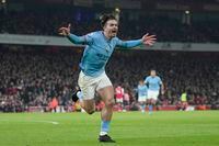 Manchester City's Jack Grealish celebrates after scoring his side's second goal during the English Premier League soccer match between Arsenal and Manchester City at the Emirates stadium in London, England, Wednesday, Feb.15, 2023. (AP Photo/Kin Cheung)