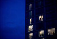 A person is seen in the window of a room at a government-authorized COVID-19 quarantine hotel in Richmond, B.C. on Sunday, February 28, 2021. THE CANADIAN PRESS/Darryl Dyck