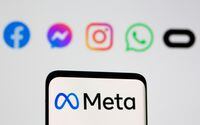 Facebook's new rebrand logo Meta is seen on smartpHone in front of displayed logo of Facebook, Messenger, Intagram, Whatsapp, Oculus in this illustration picture taken October 28, 2021.