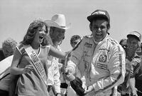 FILE - Race driver Al Unser of Albuquerque, New Mexico sprays champagne around the crowd in the winner's circle after winning the California 500 on Sunday, Sept. 3, 1978 in Ontario. Unser, one of only four drivers to win the Indianapolis 500 a record four times, died Thursday, Dec. 9, 2021, following years of health issues. He was 82. (AP Photo/Brinch, File)