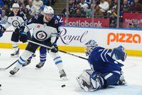 Toronto Maple Leafs goaltender Ilya Samsonov (35) makes a save as Winnipeg Jets left wing Pierre-Luc Dubois (80) looks for a rebound during third period NHL hockey action in Toronto on Thursday Jan. 19, 2023. THE CANADIAN PRESS/Nathan Denette