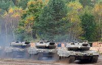 (FILES) This file photo taken on October 13, 2017 shows an armored unit with Leopard 2 A7 main battle tanks of the German armed forces Bundeswehr driving through the mud in the context of an informative educational practice "Land Operation Exercise 2017" at the military training area in Munster, northern Germany. - NATO countries are set to announce new "heavier weapons" for Ukraine, the alliance's chief said on January 18, 2023, as Ukrainian President Volodymyr Zelensky called on his backers to speed up their decision-making. US Secretary of Defence Lloyd Austin will convene a meeting of around 50 countries on January 20, 2023 at the US-run Ramstein military base in Germany, including all 30 members of the NATO alliance. The German-made Leopard 2 is seen as one of the best-performing models worldwide and is widely used across Europe, meaning spare parts and ammunition could be easily sourced. (Photo by PATRIK STOLLARZ / AFP) (Photo by PATRIK STOLLARZ/AFP via Getty Images)