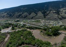 The swollen Bonaparte River runs through the Bonaparte First Nation north of Cache Creek, B.C., on Sunday, May 14, 2023. THE CANADIAN PRESS/Darryl Dyck