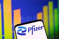 FILE PHOTO: Pfizer logo and stock graph are seen in this illustration taken, May 1, 2022. REUTERS/Dado Ruvic/Illustration/File Photo