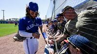 Toronto Blue Jays’ Bo Bichette signs autographs for fans before a spring training baseball game against the New York Yankees at TD Ballpark Tuesday, March 22, 2022, in Dunedin, Fla. THE CANADIAN PRESS/Steve Nesius