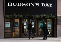 Pedestrians attempt to enter the Hudsons Bay Company flagship store which is closed due to COVID restrictions in Toronto on December 10, 2020.  /Aaron Vincent Elkaim/ The Globe and Mail