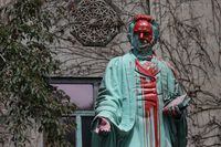 Red paint covers the defaced Ryerson University statue of Egerton Ryerson, considered an architect of Canada's residential indigenous school system, following the discovery of the remains of 215 children on the site of British Columbia's former Kamloops Indian Residential School, in Toronto, Ontario, Canada June 2, 2021.  REUTERS/Chris Helgren