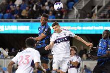 Mar 4, 2023; San Jose, California, USA; San Jose Earthquakes forward Jeremy Ebobisse (center) heads the ball for a goal against Vancouver Whitecaps defender Ranko Veselinovic (4) during the second half at PayPal Park. Mandatory Credit: Darren Yamashita-USA TODAY Sports