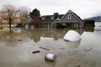 Debris flow in flood waters around a home in the Yarrow neighbourhood after rainstorms caused flooding and landslides in Chilliwack, British Columbia, Canada November 20, 2021.  REUTERS/Jesse Winter