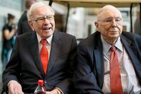 In this May 3, 2019 file photo, Berkshire Hathaway Chairman and CEO Warren Buffett, left, and Vice Chairman Charlie Munger, briefly chat with reporters before Berkshire Hathaway's annual shareholders meeting.