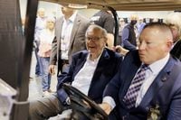Berkshire Hathaway CEO Warren Buffett rides on a golf cart through the exhibition hall as investors and guests arrive for the first in-person annual meeting since 2019 of Berkshire Hathaway Inc in Omaha, Nebraska, U.S. April 29, 2022.  REUTERS/Scott Morgan
