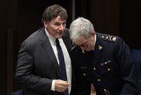 Minister of Public Safety, Democratic Institutions and Intergovernmental Affairs Dominic LeBlanc speaks with Royal Canadian Mounted Police Deputy Commissioner 
Mark Flynn as they prepare to appear at the Senate National Security, Defence and Veterans Affairs committee in Ottawa, Monday, Oct. 23, 2023. THE CANADIAN PRESS/Adrian Wyld