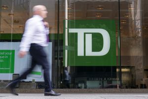 The $15.9 million settlement of a class action lawsuit related to TD Bank Group's insufficient fund fees has been approved by an Ontario Superior Court. A person makes their way past a Toronto-Dominion Bank branch in Toronto, Monday, Aug. 14, 2023. THE CANADIAN PRESS/Spencer Colby