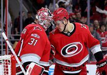 RALEIGH, NORTH CAROLINA - MAY 03: Frederik Andersen #31 celebrates with Jesse Puljujarvi #13 of the Carolina Hurricanes after a win against the New Jersey Devils during the third period in Game One of the Second Round of the 2023 Stanley Cup Playoffs at PNC Arena on May 03, 2023 in Raleigh, North Carolina. The Hurricanes won 5-1. (Photo by Grant Halverson/Getty Images)
