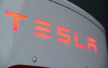 The logo of Tesla is seen at a Tesla Supercharger station October 21, 2020. REUTERS/Arnd Wiegmann/File Photo