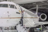 A worker shines up Bombardier's Global 7500 at the company's finishing plant in Montreal, Wednesday, Dec. 19, 2018. THE CANADIAN PRESS/Ryan Remiorz