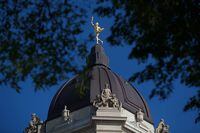 The Golden Boy stands on top of the dome of the Manitoba Legislature in Winnipeg, Saturday, Aug. 30, 2014. The Manitoba government has introduced a bill in the legislature to formally enact a raise in the minimum wage. THE CANADIAN PRESS/John Woods
