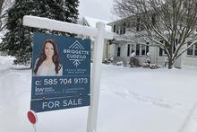 FILE - A "For Sale" sign stands in front of a house in Rochester, New York, on Monday, January 17, 2022. On Wednesday the National Association of Realtors reports on sales of existing homes in November. (AP Photo/Ted Shaffrey, File)