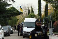 (FILES) In this file photo taken on November 30, 2022 Spanish policemen stand next to an Ukrainian flag while securing the area after a letter bomb explosion at the Ukraine's embassy in Madrid. - Spanish police have arrested a man suspected of being behind a recent letter bombing campaign that targeted the prime minister and the Ukrainian embassy, a police source said on January 25, 2023. The 74-year-old man was arrested in Miranda de Ebro in northern Spain. (Photo by OSCAR DEL POZO / AFP) (Photo by OSCAR DEL POZO/AFP via Getty Images)