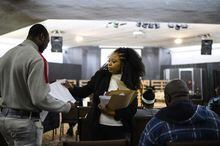 Marie Saintil, lawyer with Niagara Community Legal Clinic, meets Haitian congregants, many of whom are Asylum seekers, during a church service in Welland, Ont., on Sunday, Feb. 26, 2023. (Christopher Katsarov/The Globe and Mail)