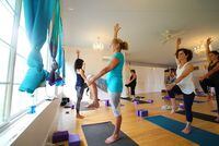 Jane Modoono, center, takes a class at Mandala Yoga in Amangansett, N.Y., Oct. 6, 2017. Retirees are well-positioned to make use of unlimited passes, as they can use them at off-peak times. Moodono and a number of other seniors holding unlimited $160 monthly passes have become regulars here. (Nicole Bengiveno/The New York Times)