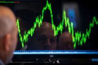 A Specialist trader watches his chart while working on the floor of the New York Stock Exchange July 8, 2014.
