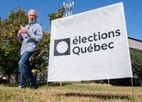 A man walks by an elections Quebec sign in L'Assomption, Que., Sunday, September 25, 2022. as advance polling begins ahead of the the Quebec election on October 3rd. THE CANADIAN PRESS/Graham Hughes 
